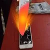 The viral 1000 Degree Knife trend: red-hot blade slicing through a phone.