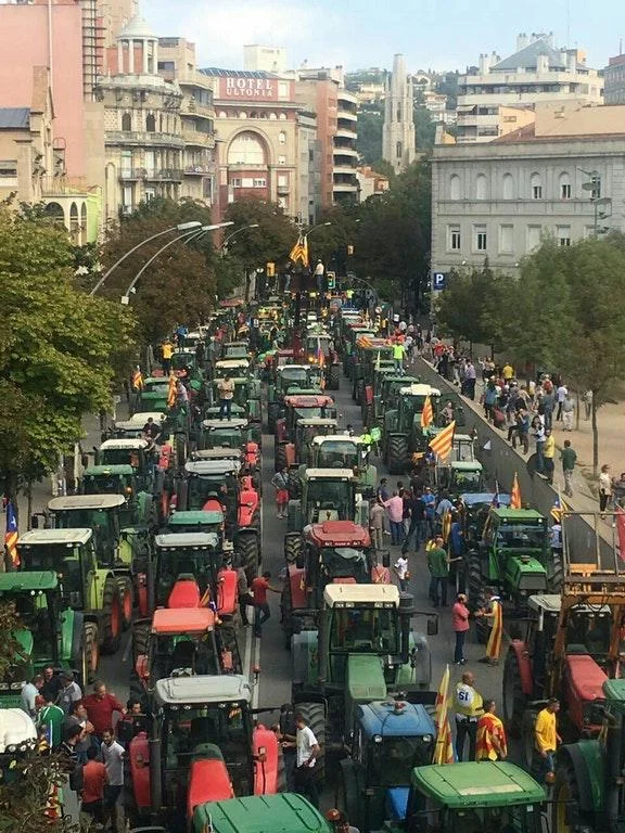 Catalan farmers block streets with their tractors in a show of support for the independence referendum.