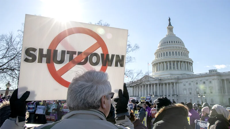 Federal workers and supporters rally against the government shutdown outside the U.S. Capitol.