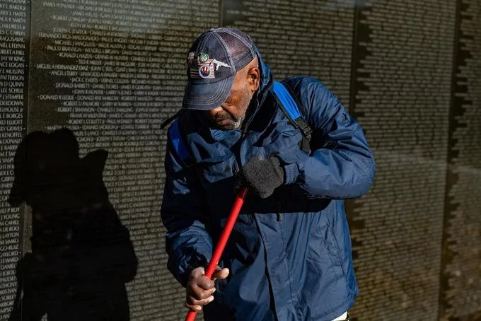 A volunteer maintains the Vietnam Veterans Memorial after National Park Service staff were furloughed during the shutdown.