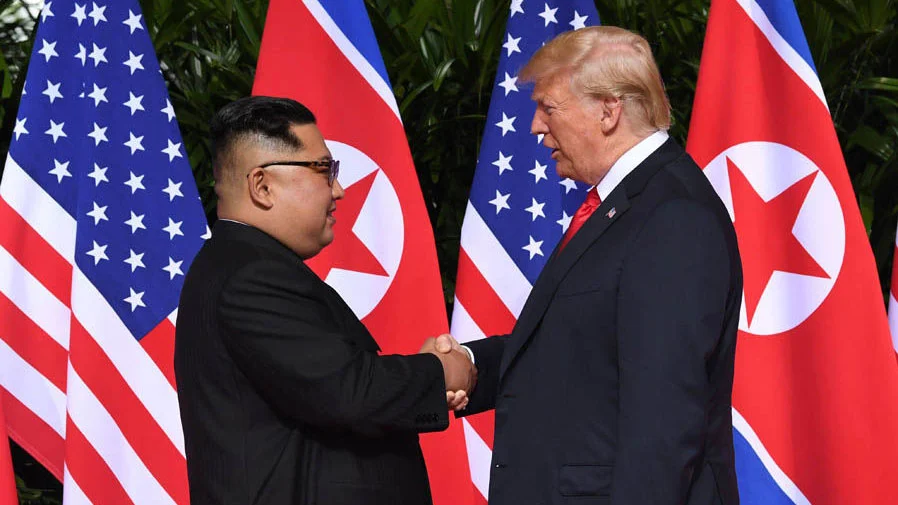 President Donald Trump and North Korean leader Kim Jong-un shake hands at the historic 2018 Singapore Summit.