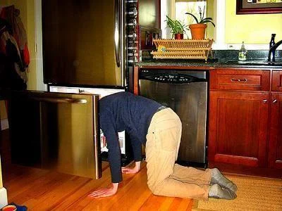 Overhead angle: head deep in freezer.