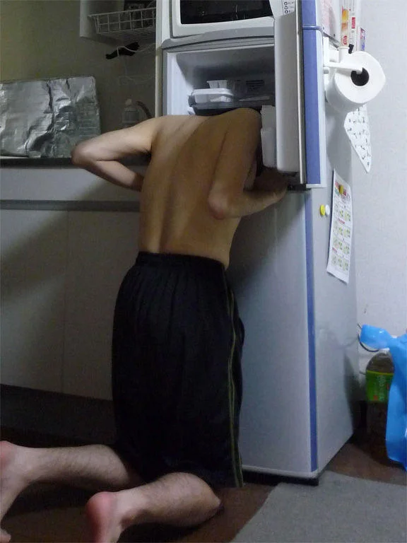 Positioned deep: head in freezer section.