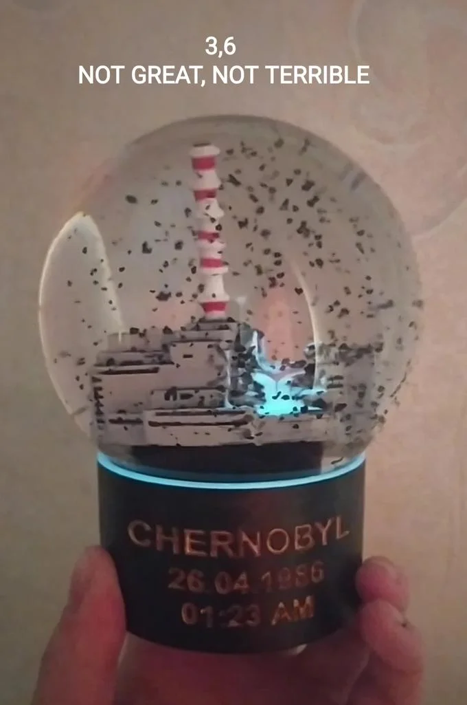 A novelty Chernobyl snow globe depicting the reactor, jokingly captioned with the '3.6 not great, not terrible' line.