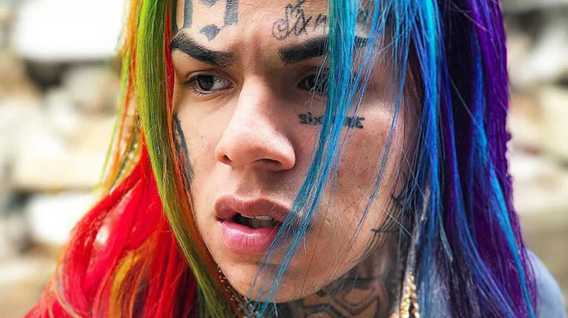 6ix9ine, known for his rainbow hair and '69' face tattoos, is the Brooklyn rapper at the center of the meme.