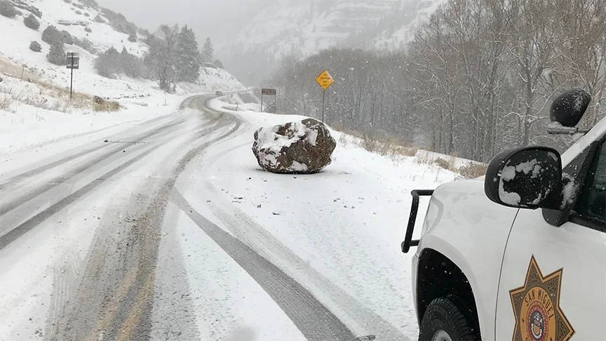 The original San Miguel Sheriff's Office photo of the boulder blocking Highway 145 that sparked the viral 'large boulder the size of a small boulder' meme.