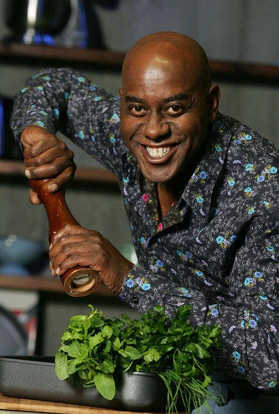 A widely circulated promotional shot of Ainsley Harriott with his signature pepper grinder, a common source image for the meme.