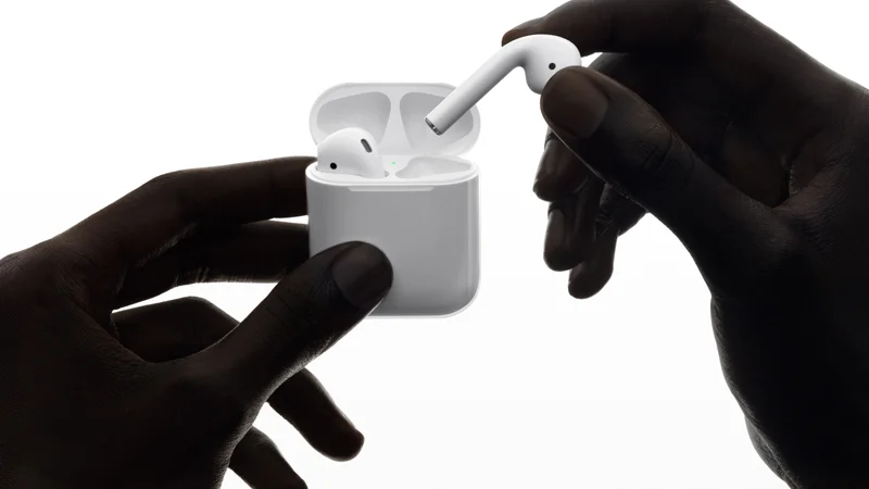 Apple's promotional image of the original AirPods and their charging case, released alongside the product launch in September 2016.
