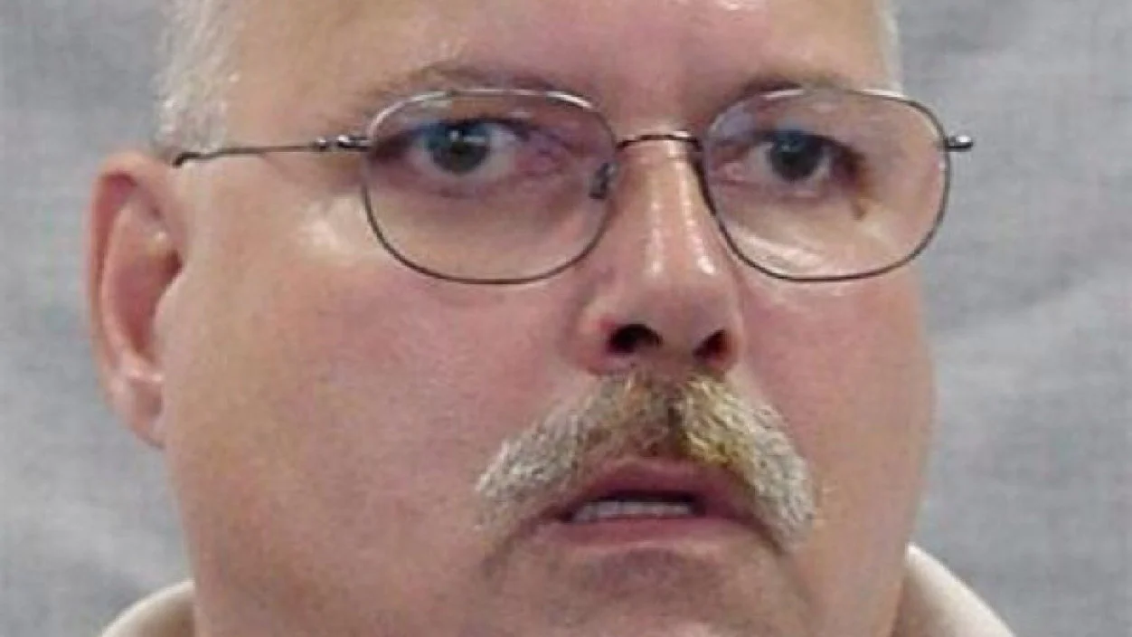 The original 'Are You a Wizard' source photo — a mugshot-style image of a bald, mustached man that became the face of the meme.