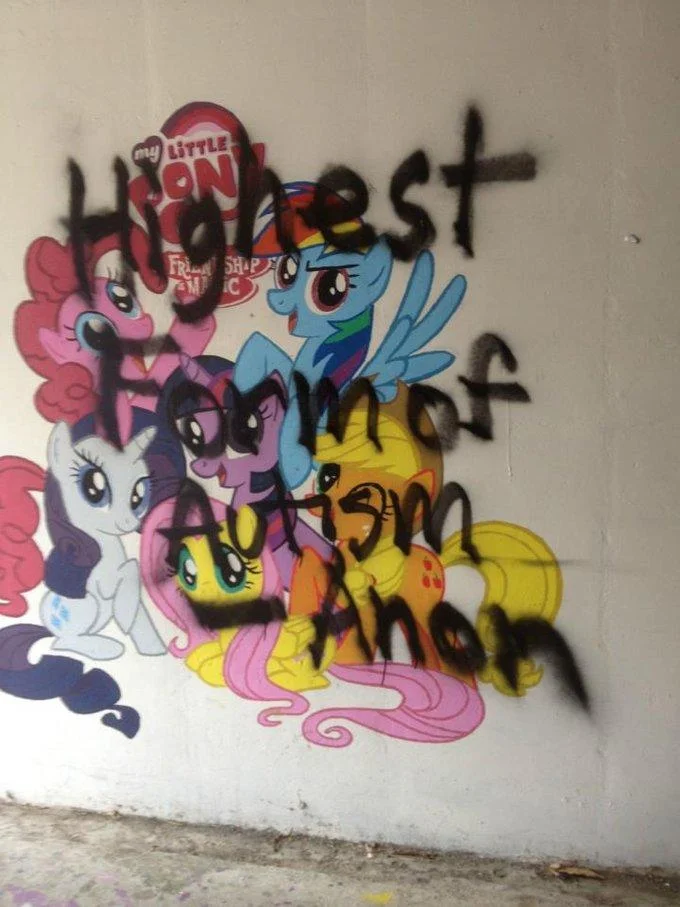 Graffiti reading 'Highest Form of Autism' scrawled across a My Little Pony mural, referencing jokes linking bronies to the term.