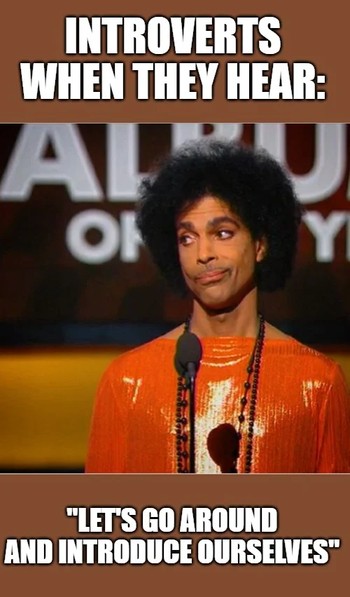 Prince in orange outfit at awards show reacting to group introduction announcement