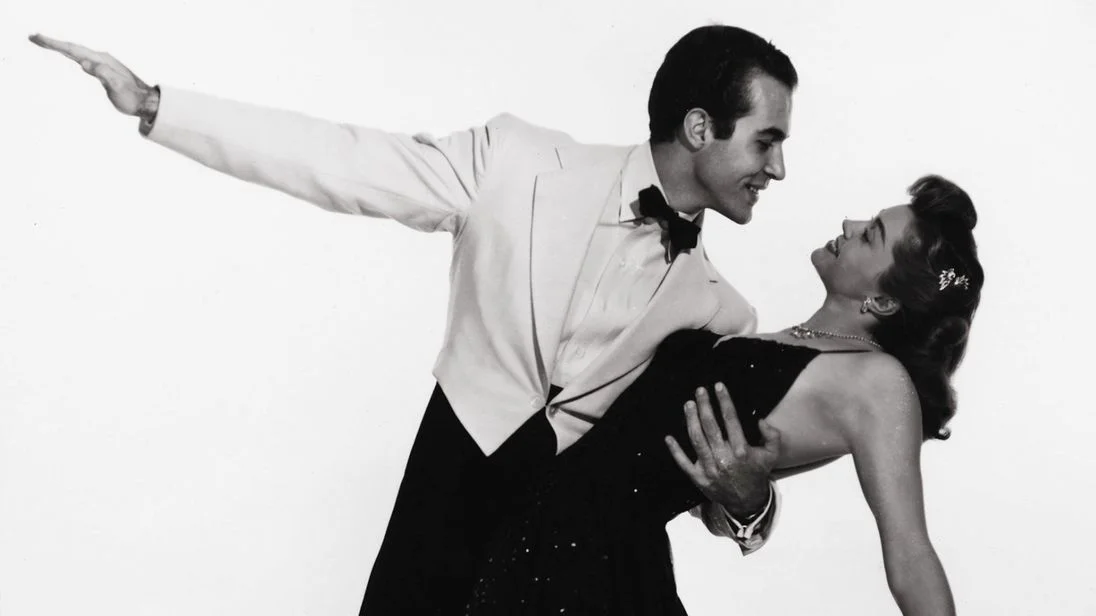 A vintage promotional still evoking the mid-century romantic-duet style of the song 'Baby, It's Cold Outside.'