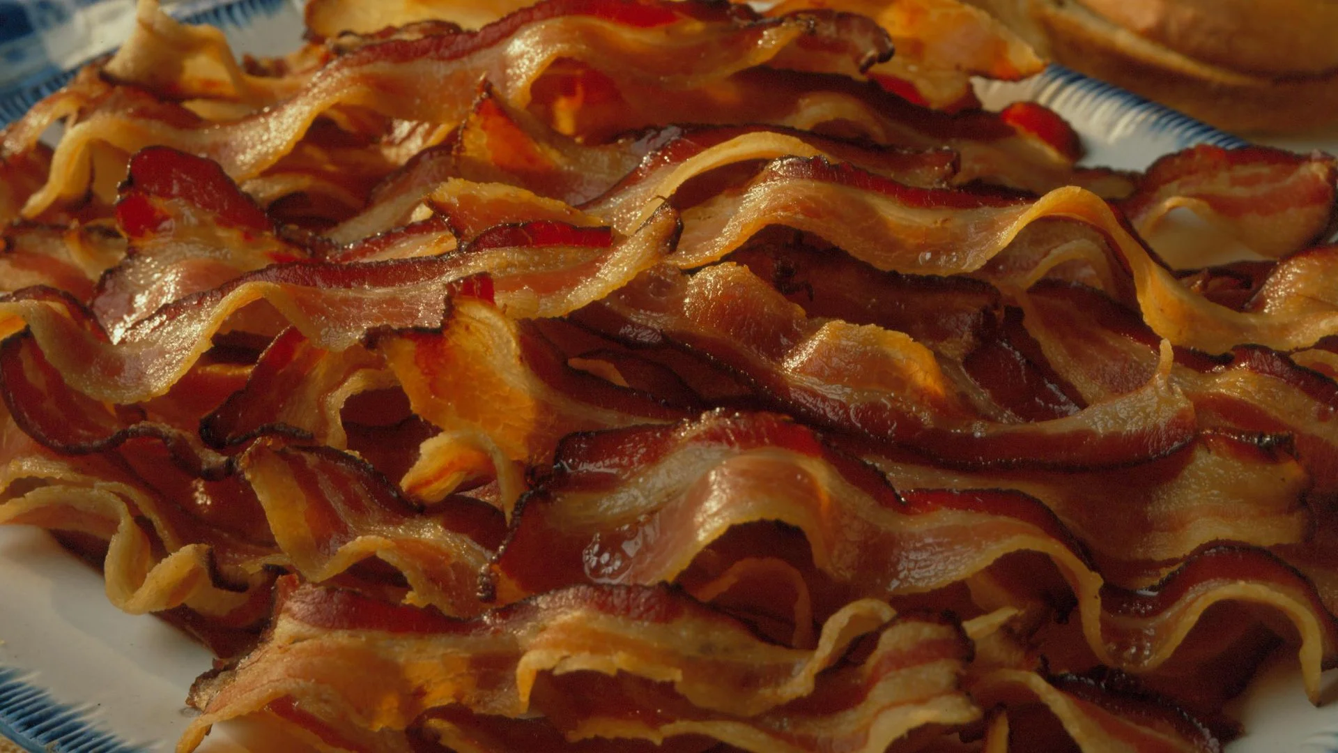 A plate piled high with crispy cooked bacon, the iconic pork product at the center of the internet's bacon obsession.