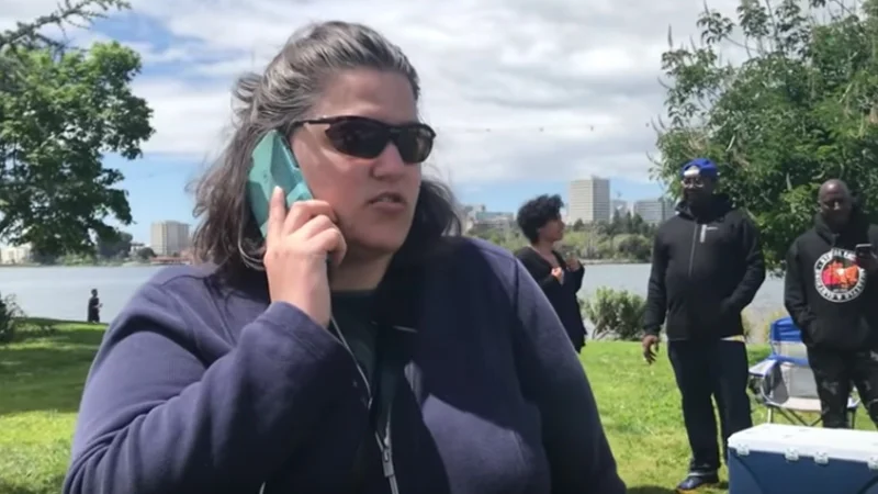 The now-iconic still of 'BBQ Becky' calling police on a Black family barbecuing at Oakland's Lake Merritt in April 2018.