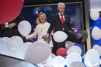 Both Clintons celebrating amid the balloon drop.