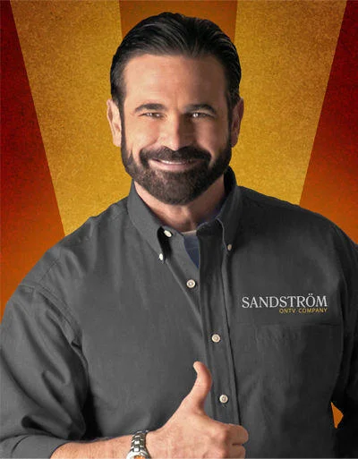 Billy Mays in his trademark promotional pose, wearing the Sandstrom On-TV Company shirt he was known for on infomercials.