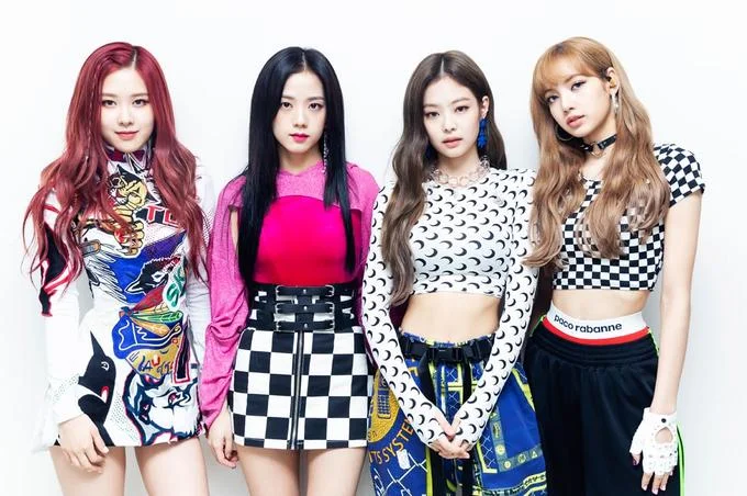 Promotional group shot of BLACKPINK showcasing the members' signature bold streetwear style.