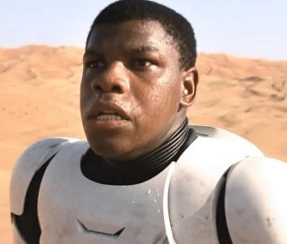 John Boyega as Finn in stormtrooper armor in the teaser trailer for Star Wars: The Force Awakens, the image that sparked the #BlackStormTrooper controversy.