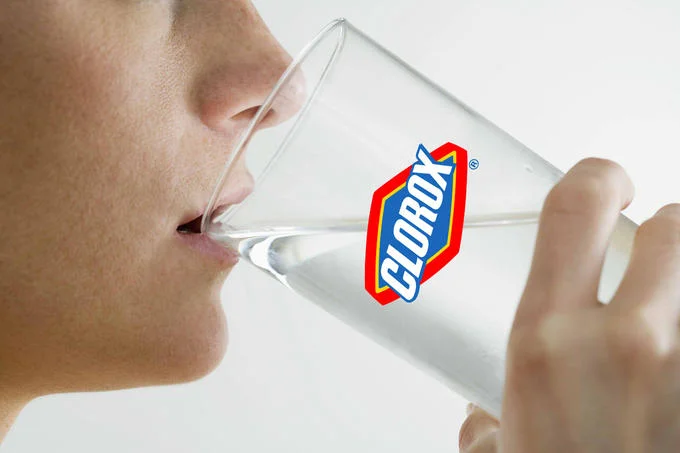 A photoshopped image of a person drinking from a glass branded with the Clorox logo, the iconic visual associated with the bleach-drinking meme.