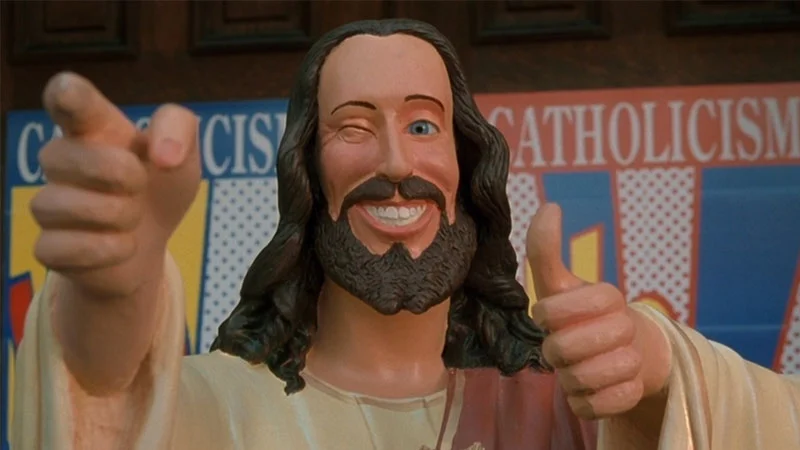 The original Buddy Christ statue from Kevin Smith's 1999 film Dogma, unveiled during the fictional 'Catholicism WOW!' campaign.