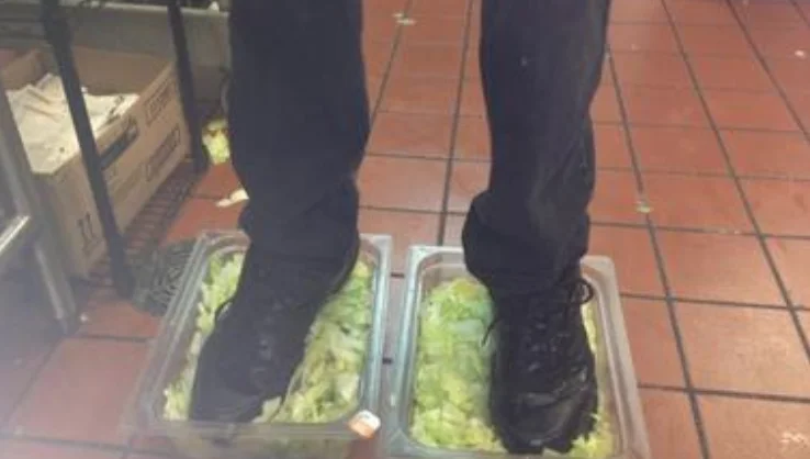 The original photograph of a Burger King employee standing in bins of lettuce, posted anonymously to 4chan in 2012.
