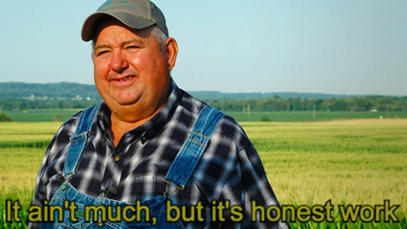 The original 'It ain't much, but it's honest work' meme template featuring a contented farmer in a rural landscape.