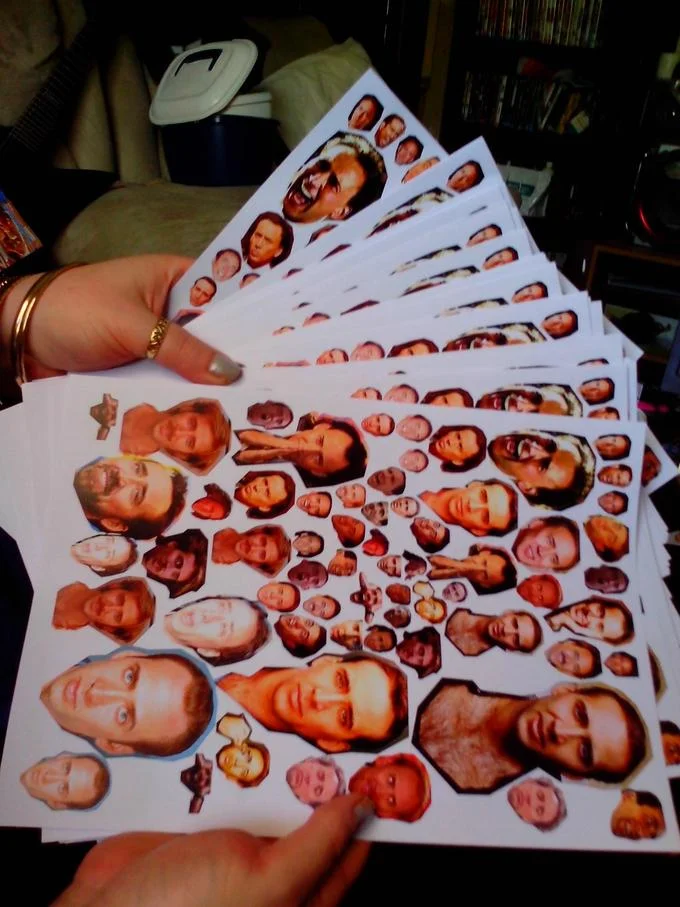 Printed sheets of Nicolas Cage face cutouts prepared as ammunition for caging pranks.