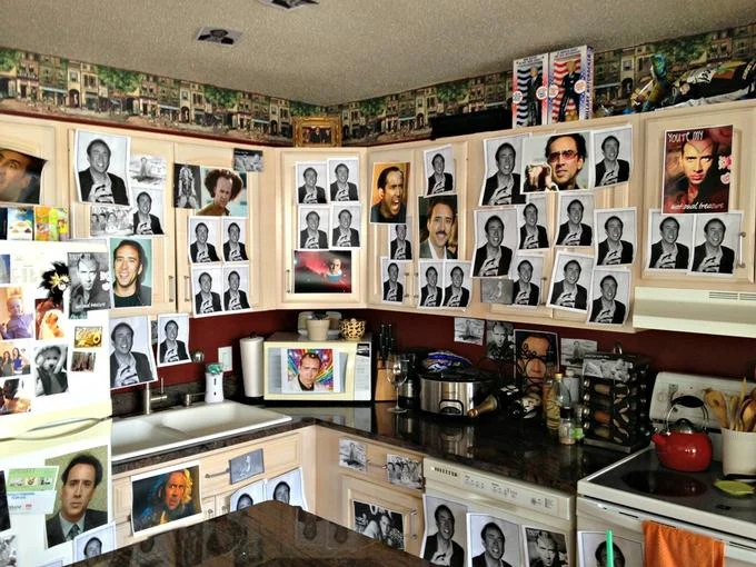 An extreme caging: an entire kitchen covered from cabinets to counters in Nicolas Cage photos.