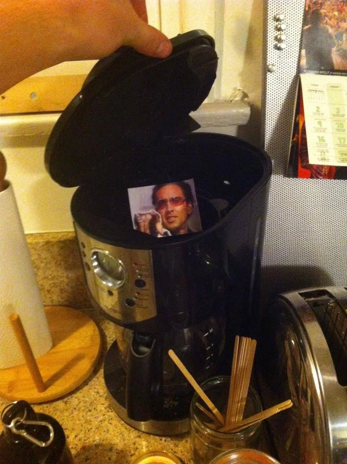 A caging prank hiding a picture of Nicolas Cage inside a household coffee maker.