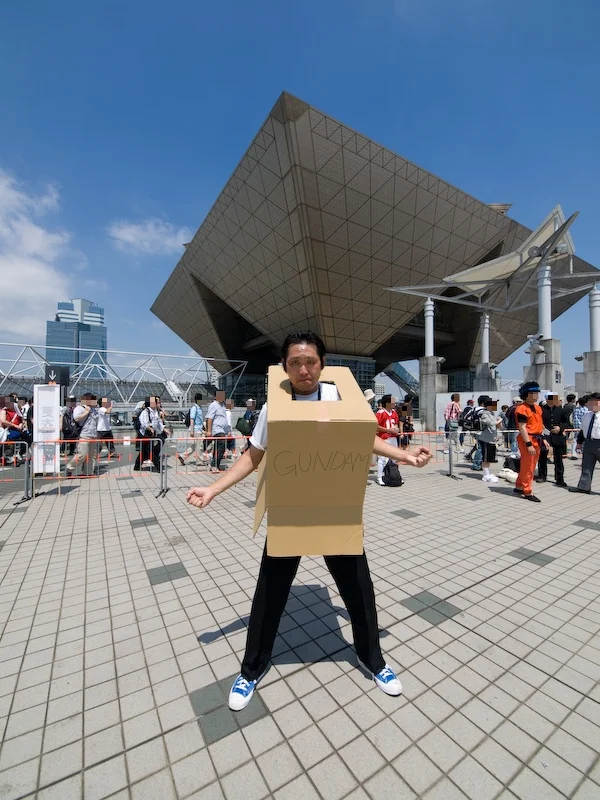 A Japanese fan pays tribute to the meme with a cardboard Gundam cosplay outside Tokyo Big Sight.