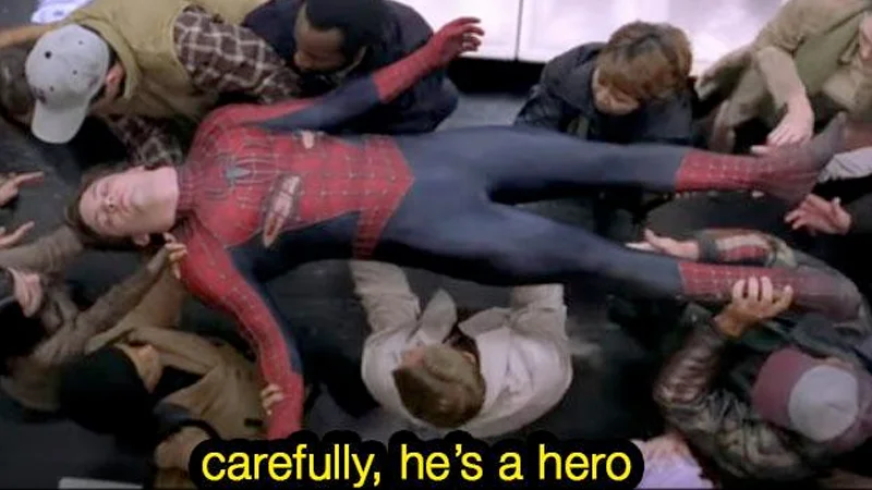 The original 'Carefully, He's a Hero' image macro from Spider-Man 2 (2004).