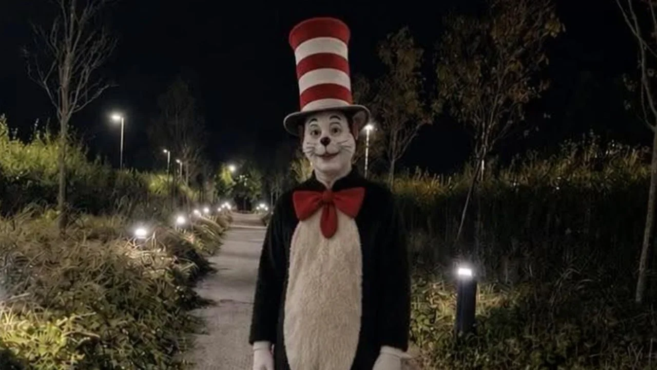 The viral photo of a person dressed as the Cat in the Hat lurking on a lamp-lined path, which helped ignite the 'Cat in the Hat Serial Killer' trend.