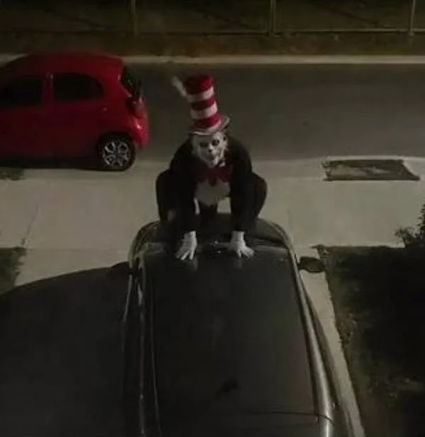 A widely shared image of the 'Cat in the Hat' figure crouched atop a car, one of the sightings that fueled the viral scare.
