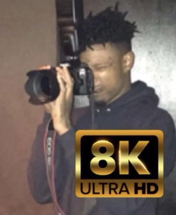 Person holding camera with "8K ULTRA HD" label overlay