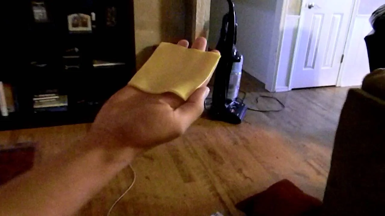 A POV shot of someone preparing to 'cheese slap' another person, the setup that became iconic to the meme.
