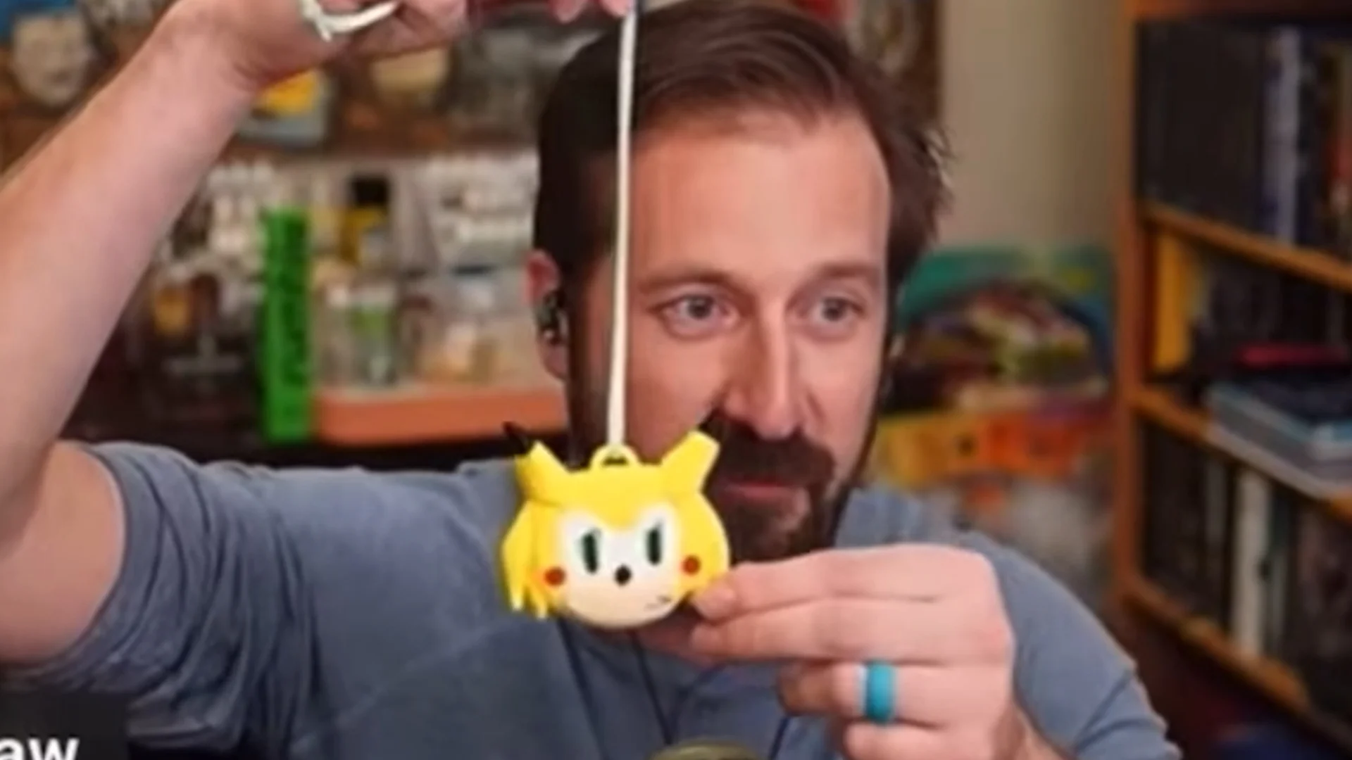 Nick Rekieta inspecting the Sonichu medallion that was mailed to him, the inciting incident of the 'Sonichu medallion curse' meme.
