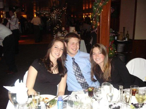 A candid photograph of the University of New Hampshire student who became the face of the College Freshman meme, seen at a formal dinner event.