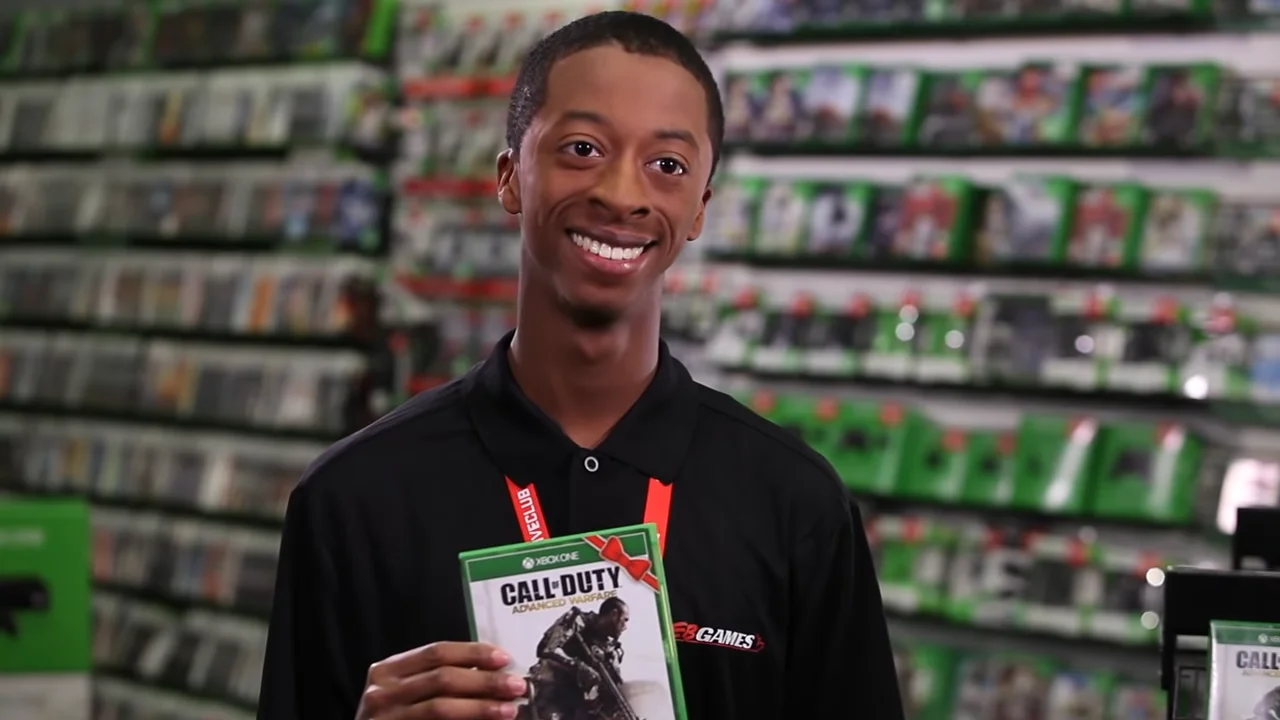 The original 'Copy That' still: a GameStop employee grins while holding a copy of Call of Duty.