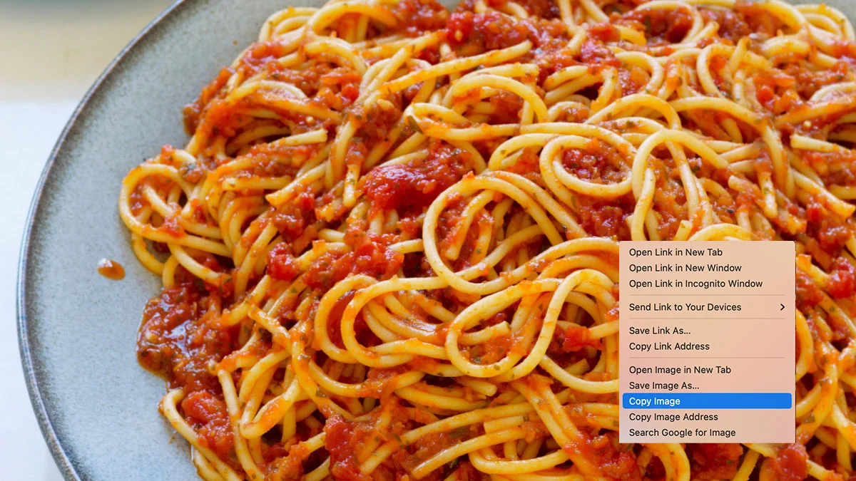 The iconic visual pun for the term 'copypasta', combining a plate of spaghetti with a browser 'Copy Image' menu option.