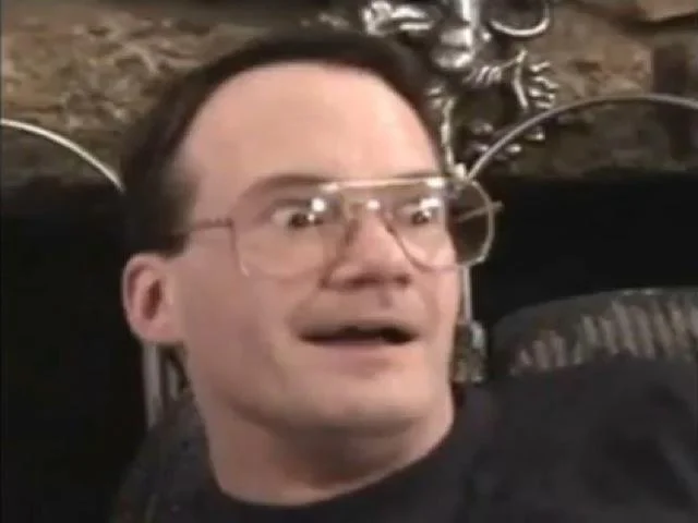 An alternate frame from the same interview showing another exaggerated Cornette Face expression.