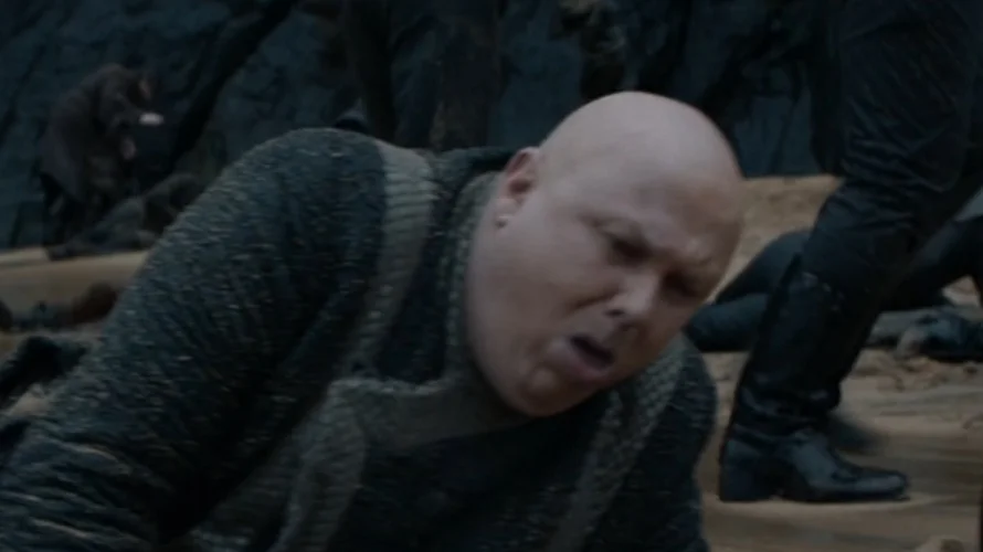 The original scene from Game of Thrones season 8 where Varys is seen coughing during the aftermath of a battle, which became the basis for the meme.