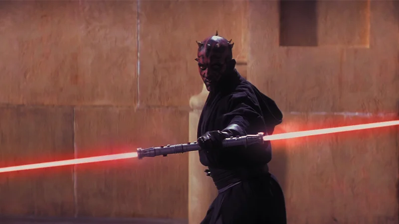 Darth Maul brandishes his iconic double-bladed lightsaber in a scene from Star Wars: The Phantom Menace, the source image for the meme template.