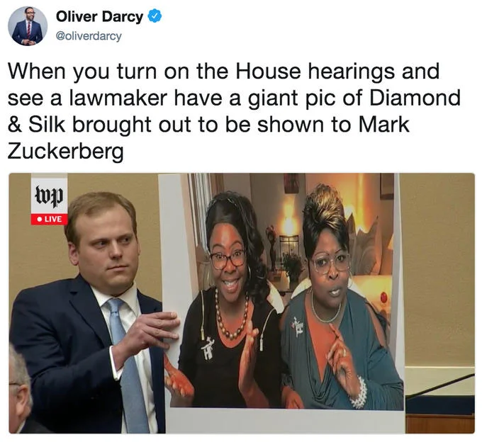 A US lawmaker displays a large photo of Diamond and Silk during Mark Zuckerberg's House hearing on Facebook censorship.