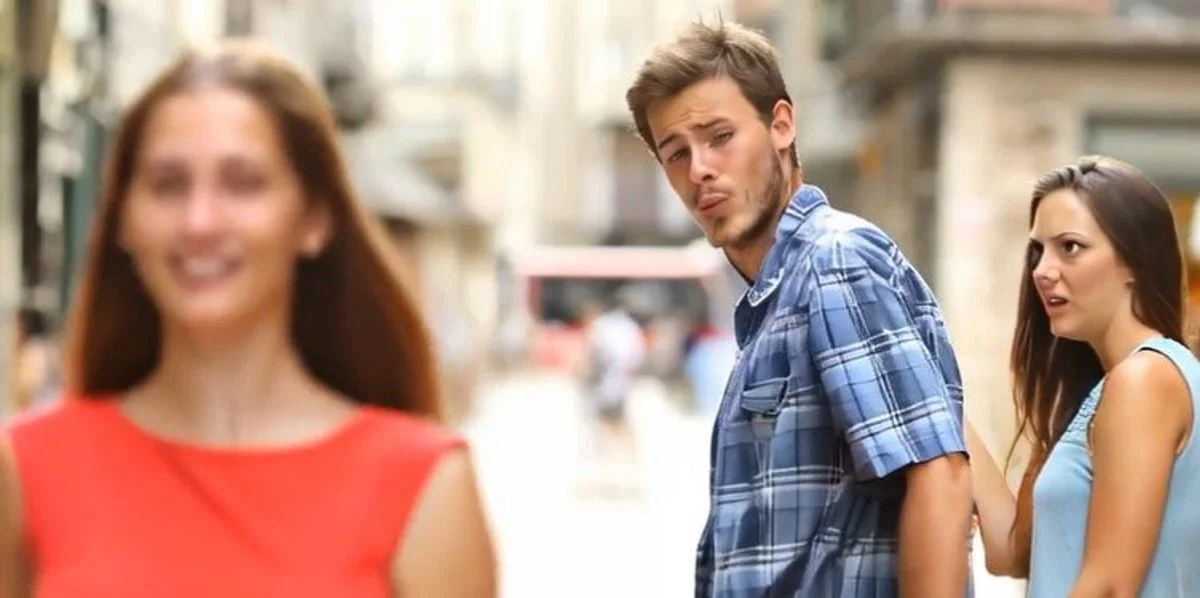 Wide-crop Distracted Boyfriend photo without labels.