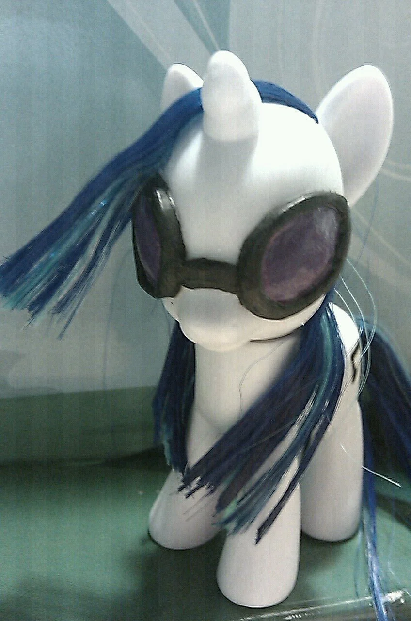 A humanized interpretation of DJ P0n-3, retaining her signature blue hair, tinted glasses, and headphones.