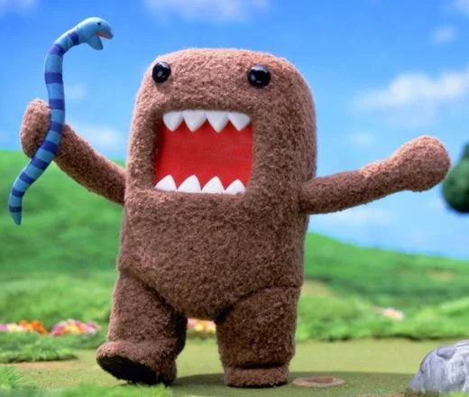 Domo-kun, the NHK mascot who inspired the internet meme, shown in his signature stop-motion promotional style.
