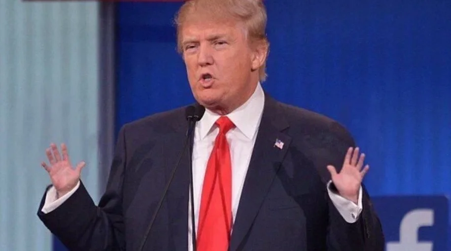 Donald Trump gestures with both hands raised during the Fox News Republican primary debate, one of the moments that fueled the 'small hands' meme.