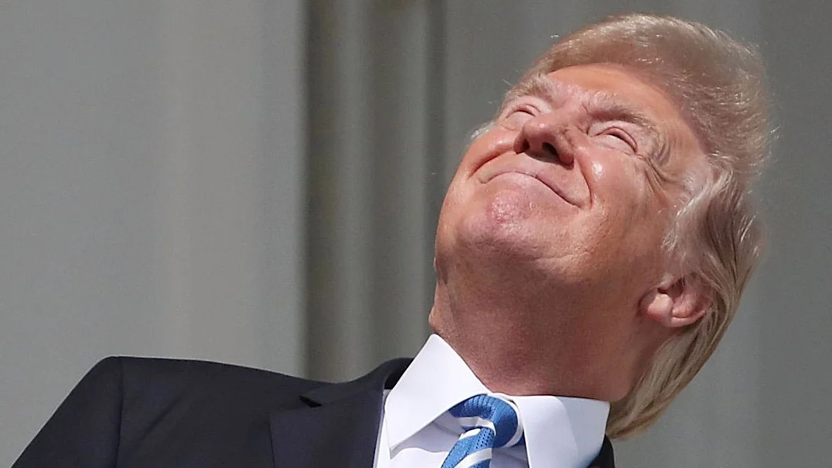 The original close-up shot of President Trump looking up at the 2017 solar eclipse without protective eyewear, which became the foundation of the meme.