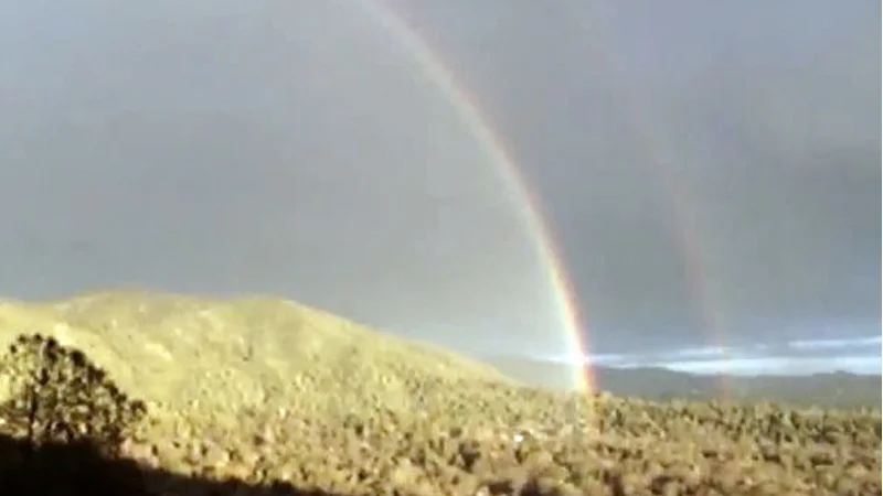 Natural double rainbow desert scene.