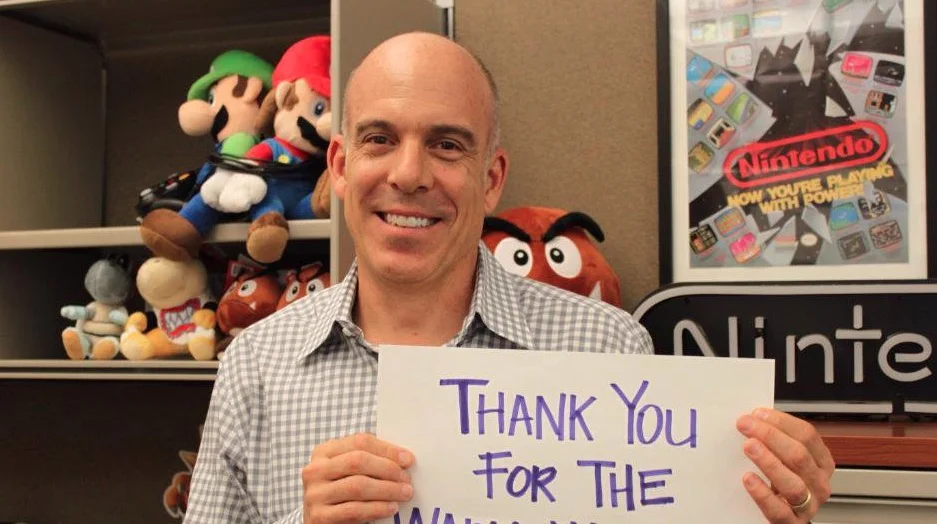 Doug Bowser, then Nintendo of America's Vice President of Sales, poses with a handwritten thank-you note in the original 2015 tweet that later inspired the meme.